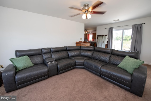 living room with carpet flooring, a ceiling fan, and visible vents