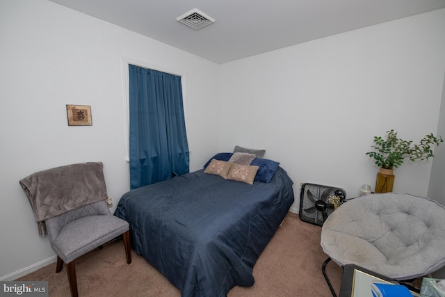 carpeted bedroom featuring baseboards and visible vents