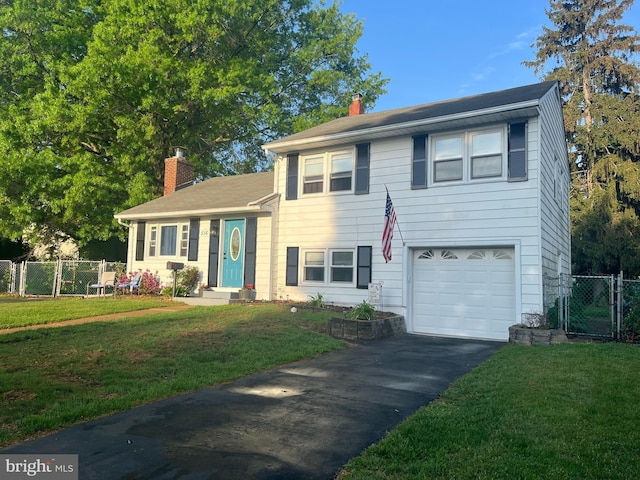 split level home featuring a chimney, driveway, a gate, and a garage