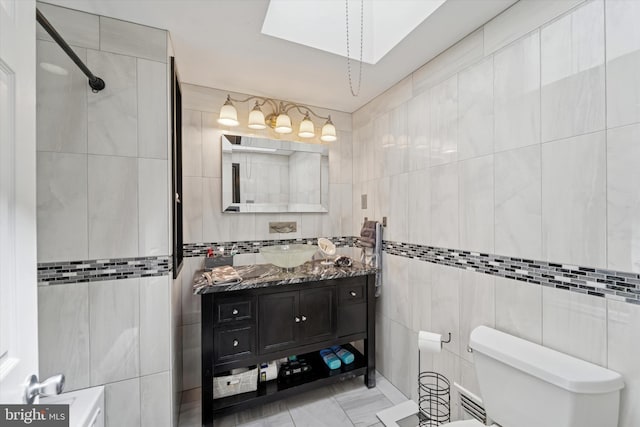 11757 Dimarco Dr, Philadelphia, PA 19154 - full bath featuring tile walls, a skylight, toilet, vanity, and tiled shower