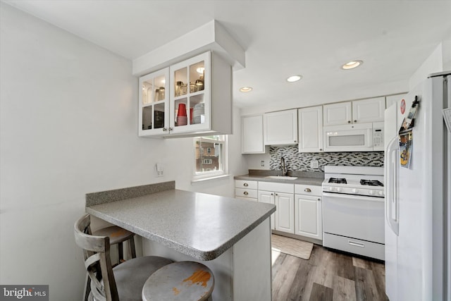 11757 Dimarco Dr, Philadelphia, PA 19154 - kitchen with white appliances, a sink, a peninsula, white cabinets, and recessed lighting