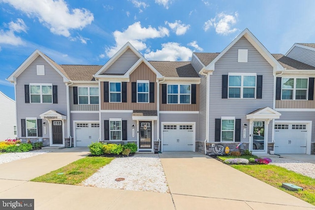 28020 Dew Drop Ln, Millville, DE 19967 - multi unit property featuring board and batten siding, driveway, roof with shingles, an attached garage, and stone siding