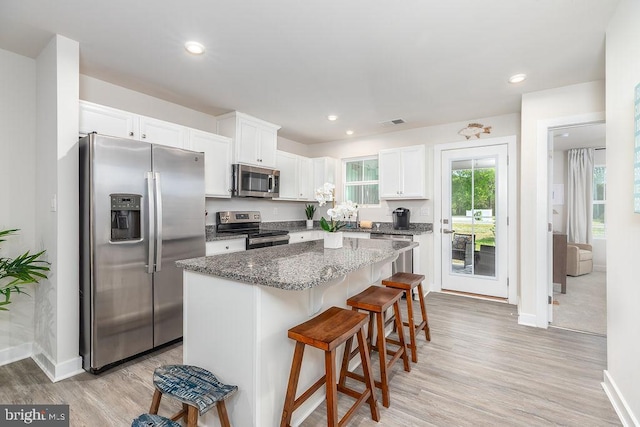 28020 Dew Drop Ln, Millville, DE 19967 - kitchen with white cabinets, stainless steel appliances, baseboards, and a center island