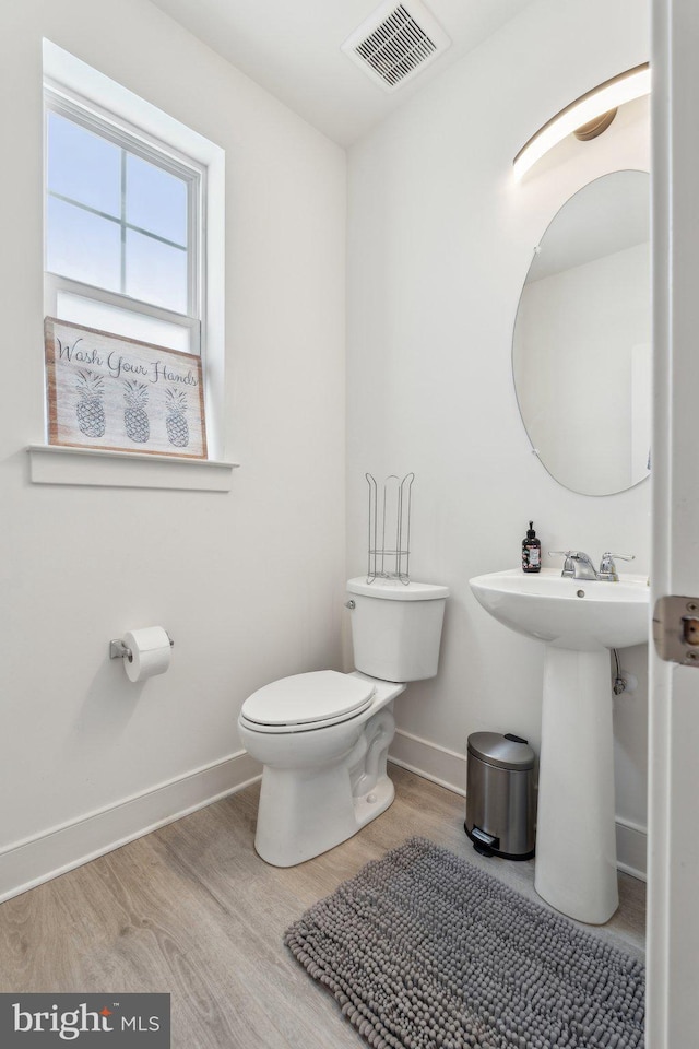1490 Meadowlark Glen Rd, Dumfries, VA 22026 - bathroom with toilet, wood finished floors, baseboards, and a sink