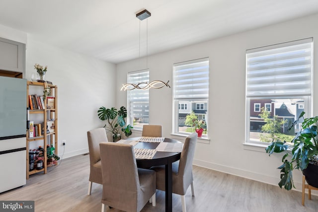 1490 Meadowlark Glen Rd, Dumfries, VA 22026 - dining area featuring light wood finished floors, baseboards, and a chandelier