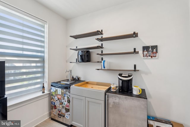 1490 Meadowlark Glen Rd, Dumfries, VA 22026 - indoor wet bar featuring refrigerator and light wood finished floors