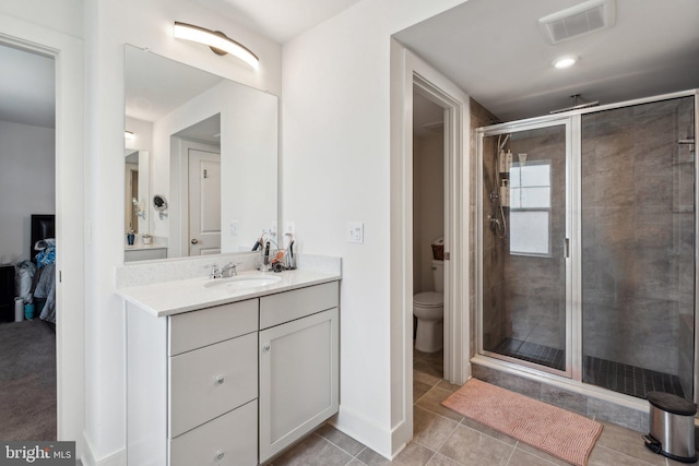 1490 Meadowlark Glen Rd, Dumfries, VA 22026 - bathroom featuring a stall shower, vanity, toilet, and tile patterned flooring