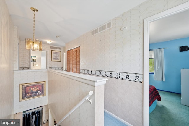 stairway featuring carpet and visible vents