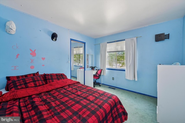 carpeted bedroom featuring baseboards and visible vents