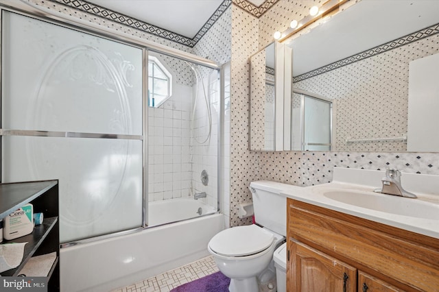 bathroom featuring vanity, enclosed tub / shower combo, and toilet