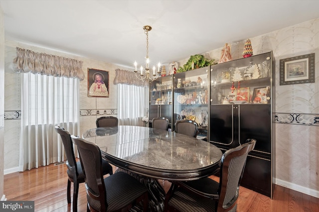 dining area with a notable chandelier and wood finished floors