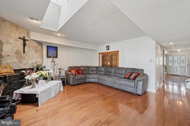 living room featuring a textured ceiling and wood finished floors