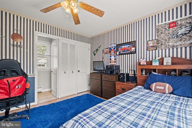 bedroom with tile patterned flooring, a closet, ceiling fan, and wallpapered walls
