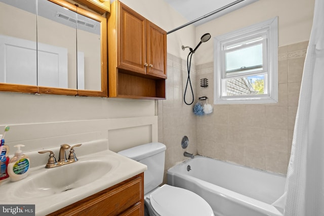 bathroom featuring vanity, shower / tub combo with curtain, toilet, and visible vents