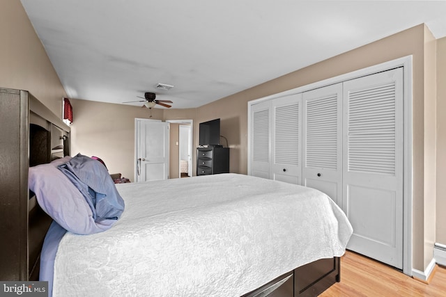 bedroom featuring a closet, light wood-style floors, and ceiling fan