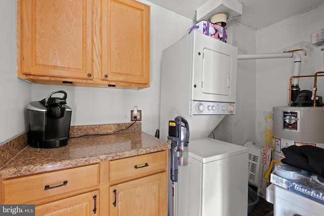 clothes washing area with gas water heater and stacked washer / drying machine