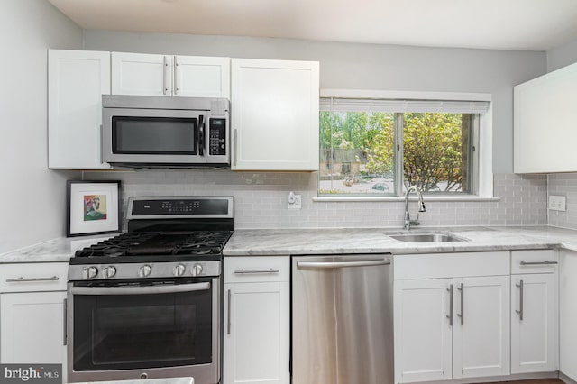 kitchen with white cabinets, stainless steel appliances, and a sink