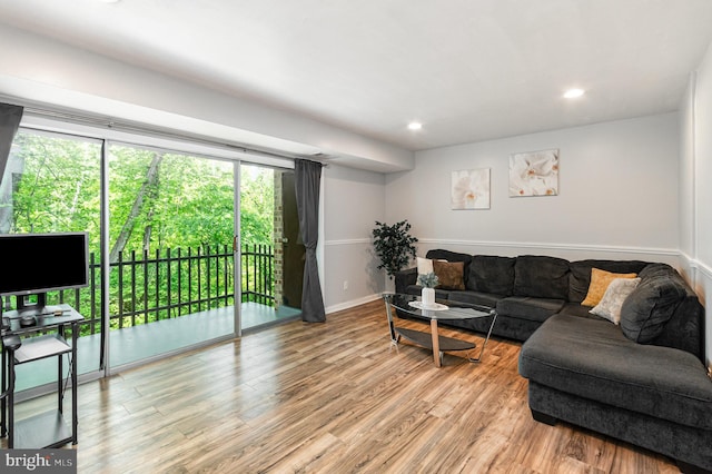 living area with recessed lighting and light wood finished floors