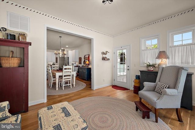 38284 Clearwater Ct, Ocean View, DE 19970 - living area featuring light wood finished floors, visible vents, baseboards, and a notable chandelier