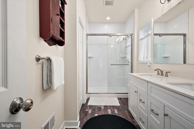 38284 Clearwater Ct, Ocean View, DE 19970 - bathroom with a shower stall, visible vents, brick floor, and a sink