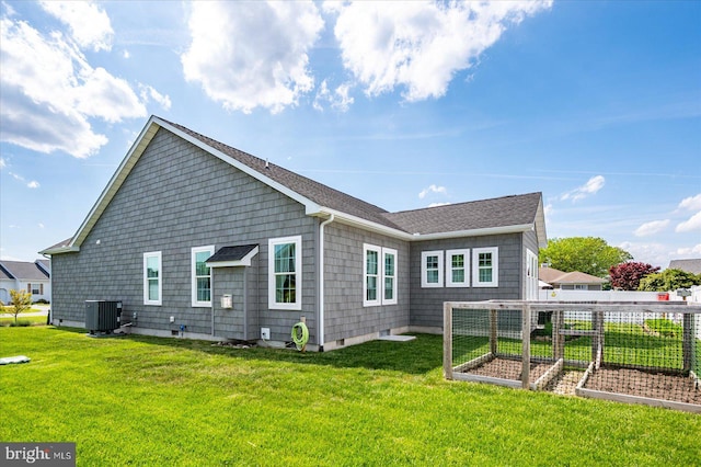 38284 Clearwater Ct, Ocean View, DE 19970 - rear view of property with cooling unit, a vegetable garden, and a lawn
