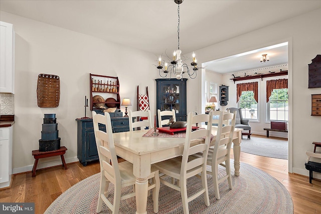38284 Clearwater Ct, Ocean View, DE 19970 - dining room with baseboards, a chandelier, and light wood-style flooring