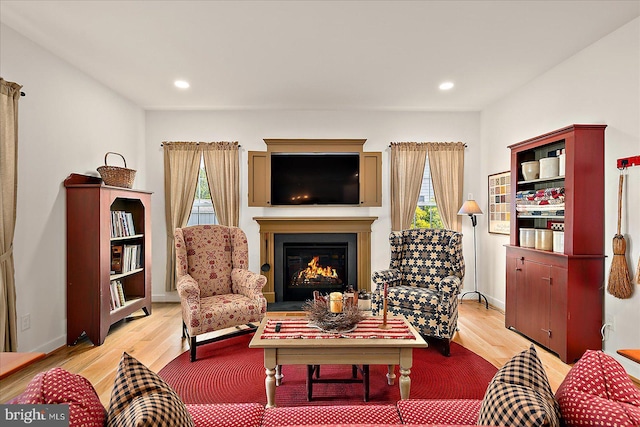 38284 Clearwater Ct, Ocean View, DE 19970 - living area with a lit fireplace, light wood-style flooring, and recessed lighting