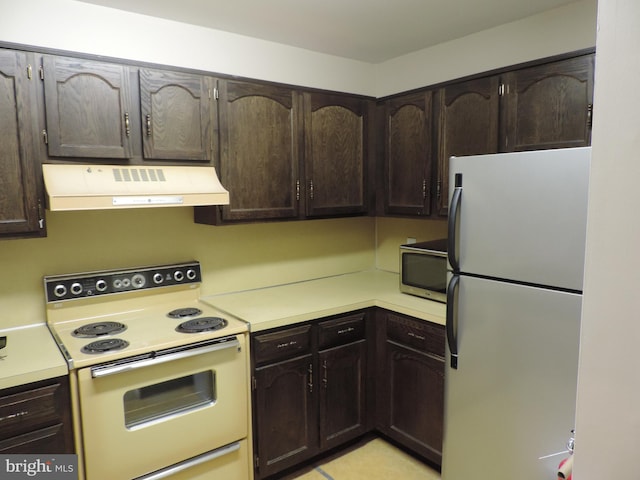 25 Church Rd Unit 007, Maple Shade, NJ 08052 - kitchen with white appliances, dark brown cabinetry, ventilation hood, and light countertops