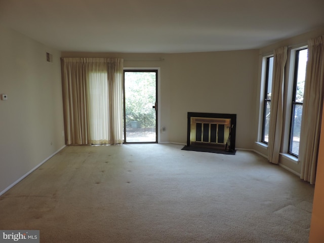 25 Church Rd Unit 007, Maple Shade, NJ 08052 - unfurnished living room featuring baseboards, a fireplace with flush hearth, a healthy amount of sunlight, and carpet flooring