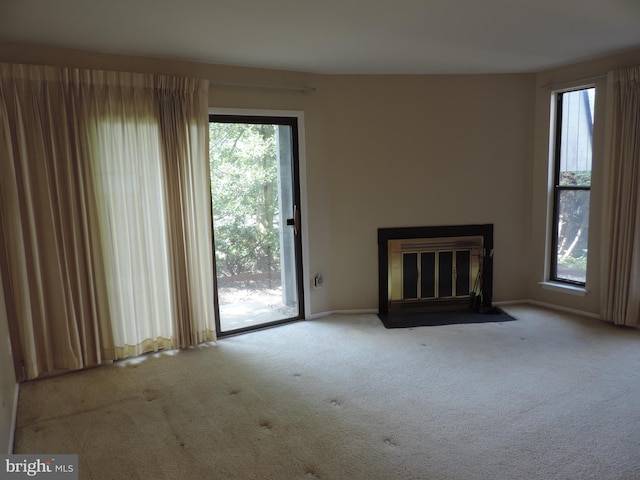 25 Church Rd Unit 007, Maple Shade, NJ 08052 - unfurnished living room with a fireplace with flush hearth, baseboards, plenty of natural light, and carpet