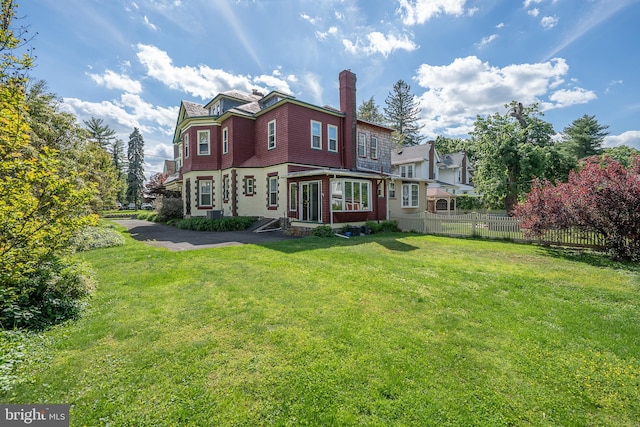 rear view of house featuring a chimney