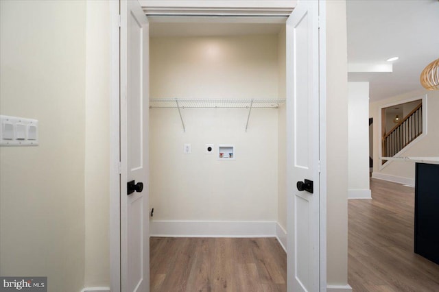 clothes washing area featuring laundry area, wood finished floors, baseboards, washer hookup, and hookup for an electric dryer