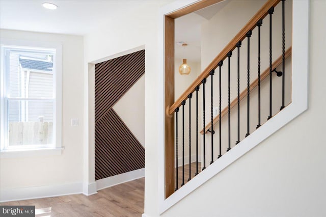staircase featuring baseboards, recessed lighting, and wood finished floors