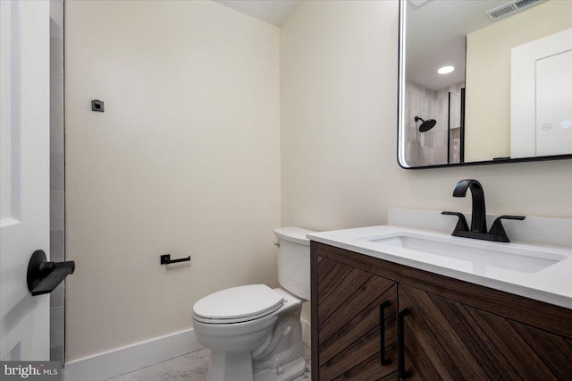 bathroom featuring vanity, toilet, marble finish floor, baseboards, and visible vents