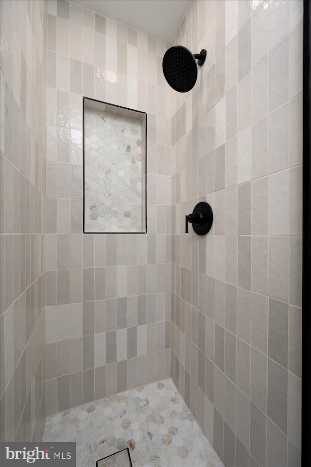 full bath with a tile shower