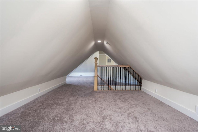 bonus room with carpet and vaulted ceiling