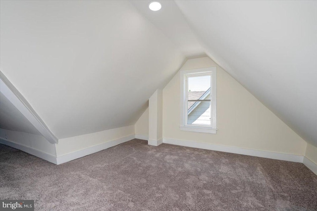 bonus room with carpet floors, baseboards, and lofted ceiling