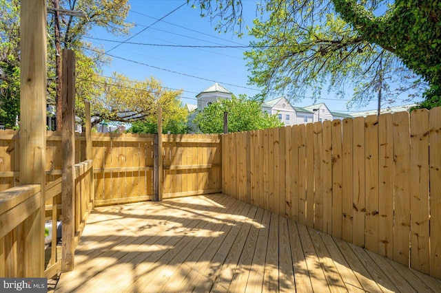 wooden terrace featuring fence