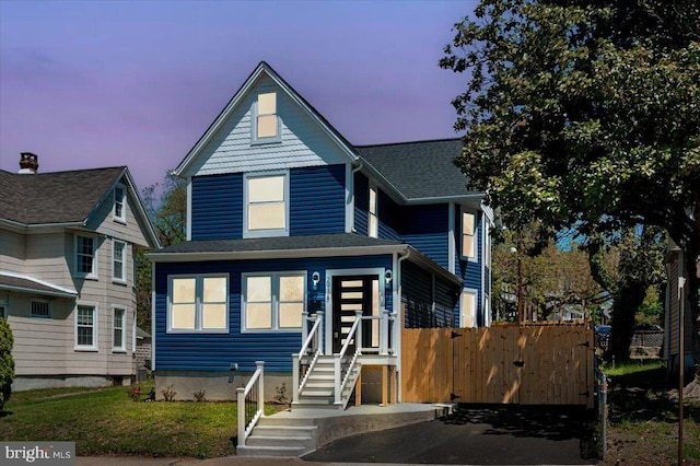 view of front facade with fence and entry steps