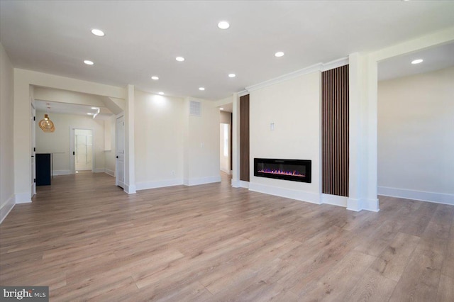 unfurnished living room with recessed lighting, visible vents, and light wood-style floors