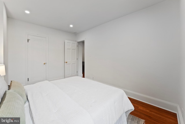 bedroom featuring baseboards, recessed lighting, and dark wood-type flooring