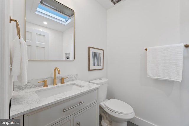 bathroom featuring toilet and vanity