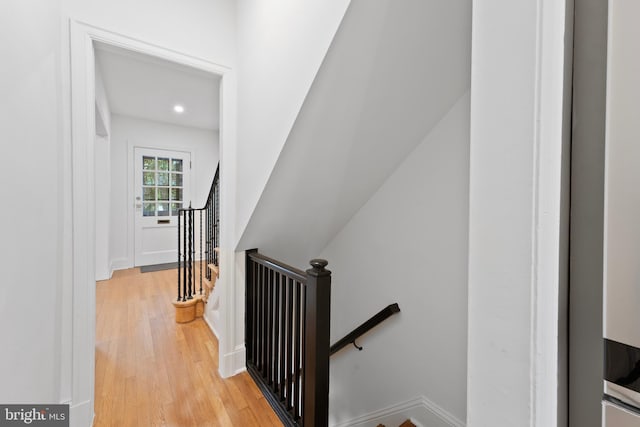 stairway with baseboards, recessed lighting, and wood finished floors