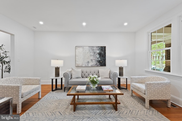 living room with baseboards, recessed lighting, and wood finished floors