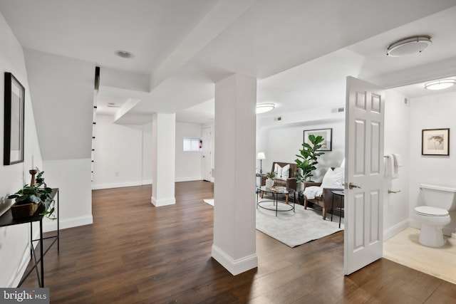 interior space with baseboards and dark wood finished floors