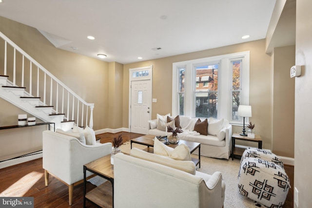 living area with recessed lighting, baseboards, wood finished floors, and stairway