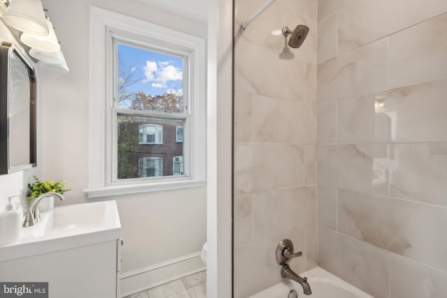 bathroom featuring vanity, marble finish floor, shower / bathtub combination, toilet, and baseboards