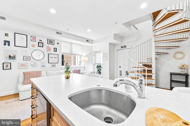 kitchen featuring visible vents, dishwasher, a sink, open floor plan, and recessed lighting
