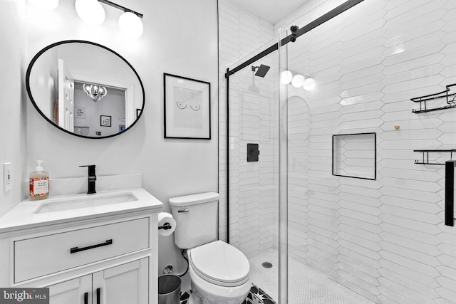 bathroom with vanity, toilet, and a shower stall