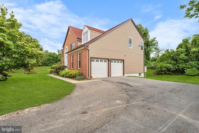 601 James Ridge Rd, Bowie, MD 20721 - view of property exterior featuring asphalt driveway, a lawn, and brick siding